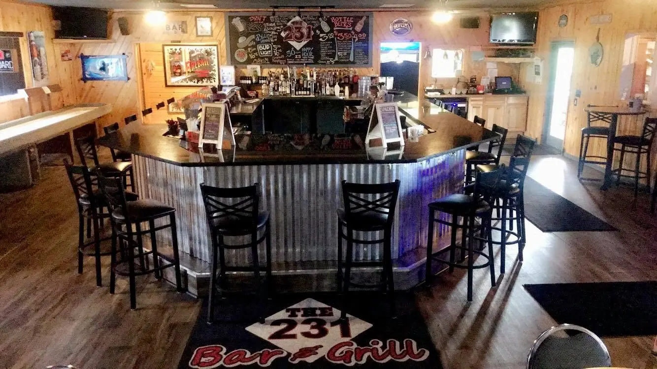 The horseshoe bar at The 231 Bar & Grill with corrugated metal and wood trim